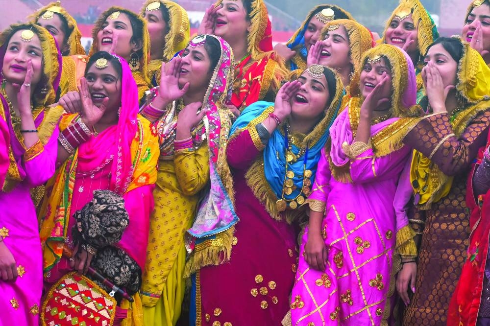 Schoolgirls cheer after they perform a Punjabi folk dance ‘Giddha’ during a full-dress rehearsal for the upcoming Republic Day at the Guru Nanak Stadium, in Amritsar, on Wednesday.