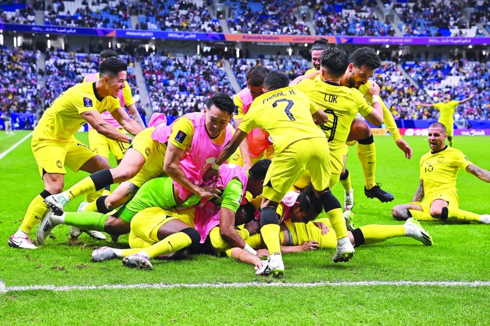 Malaysia’s players celebrate their team’s third goal during the Qatar 2023 AFC Asian Cup Group E match against South Korea at 
Al Janoub Stadium in Al Wakra, south of Doha, on Thursday. (AFP)