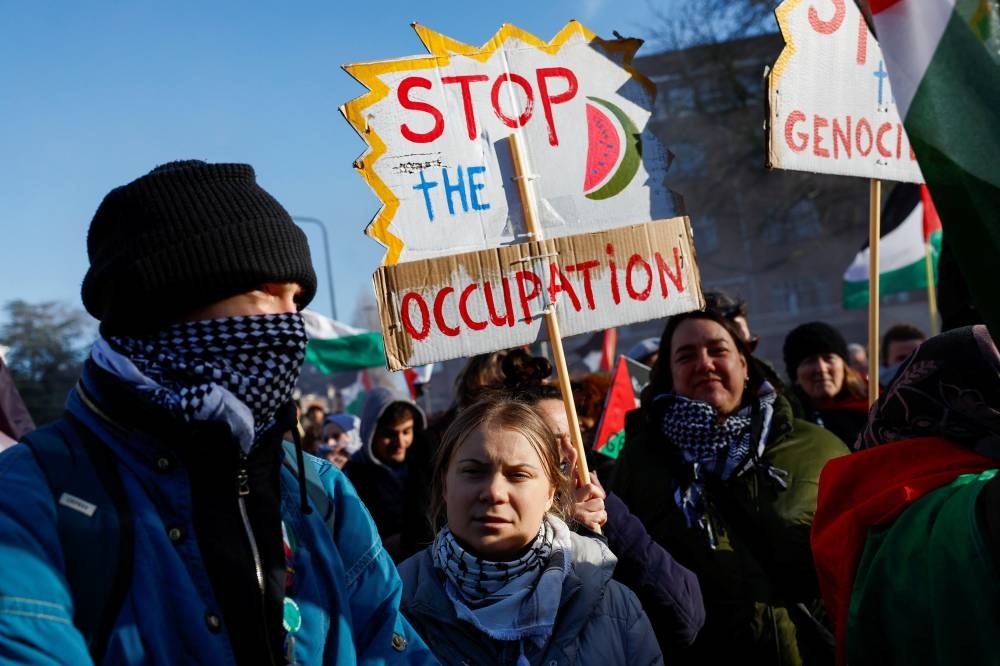Swedish climate activist Greta Thunberg attends a protest outside the International Court of Justice (ICJ) as judges rule on emergency measures against Israel following accusations by South Africa that the Israeli military operation in Gaza is a state-led genocide, in The Hague, Netherlands, on Friday. REUTERS