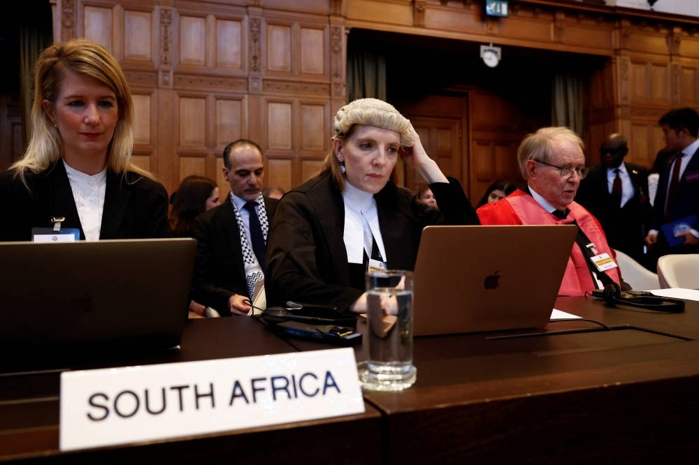 Irish Lawyer Blinne Ni Ghralaigh and a member of South African legal team John Dugard sit on the day the International Court of Justice (ICJ) rule on emergency measures against Israel following accusations by South Africa that the Israeli military operation in Gaza is a state-led genocide, in The Hague, Netherlands, on Friday. REUTERS