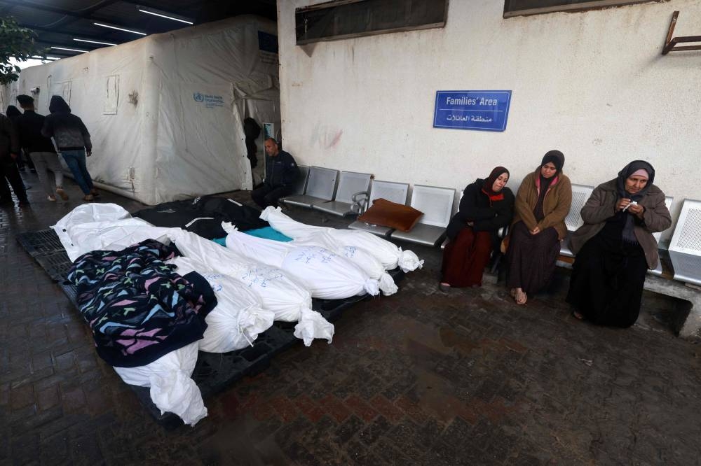 Corpses of people killed in Israeli bombing are lined up outside the morgue of the Al-Najjar hospital in Rafah in the southern Gaza Strip  on Saturday. AFP