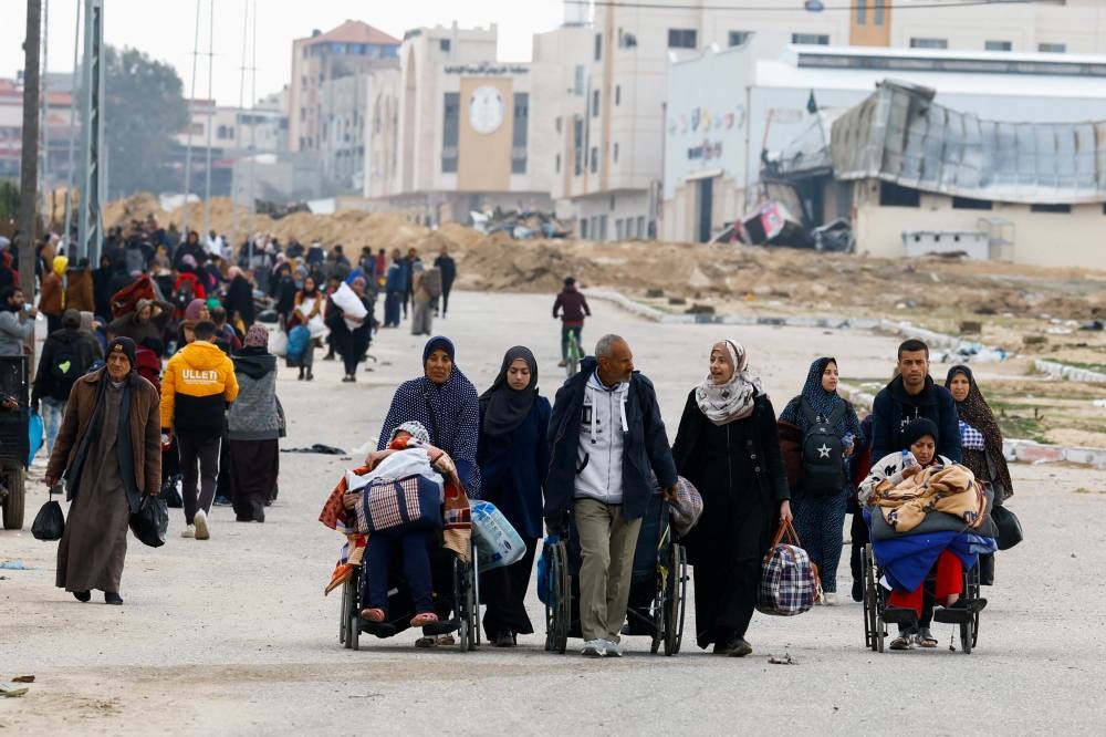 Palestinians fleeing Khan Younis, due to the Israeli ground operation, move towards Rafah in the southern Gaza Strip, on Sunday. REUTERS