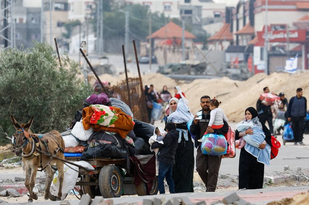 Palestinians fleeing Khan Younis, move towards Rafah, in the southern Gaza Strip, Sunday.