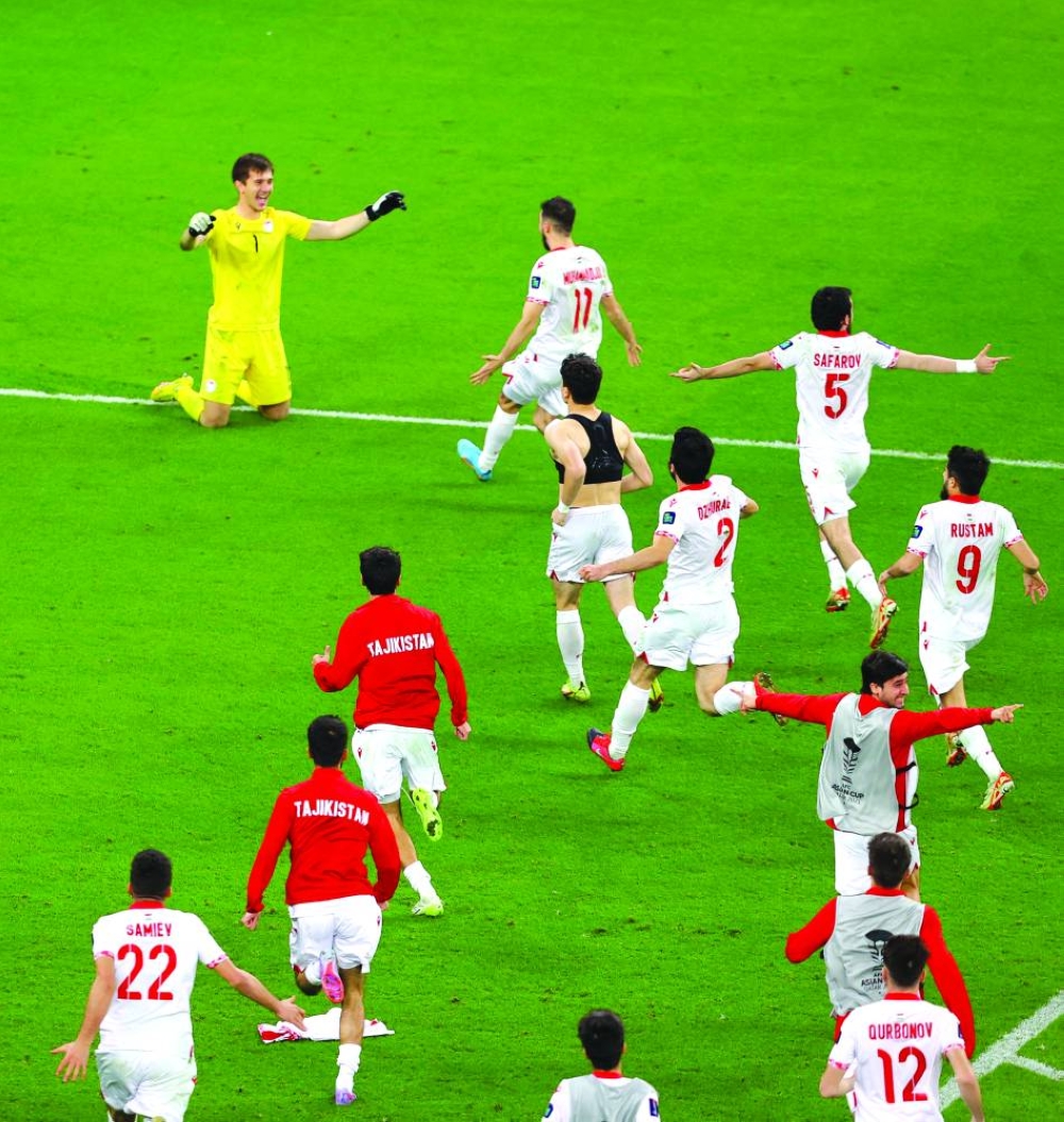
Tajikistan’s Rustam Yatimov (left) celebrates with teammates after winning the shootout against United Arab Emirates in the round of 16 clash at Ahmad Bin Ali Stadium. (Reuters) 