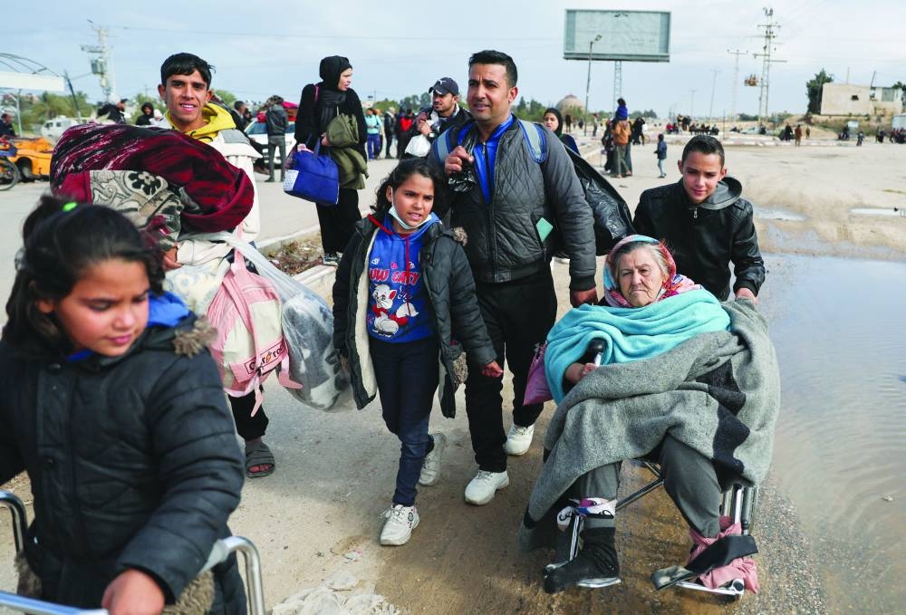 Palestinians fleeing Khan Younis, due to the Israeli ground operation, move towards Rafah, amid the ongoing conflict, in the southern Gaza Strip, yesterday.
