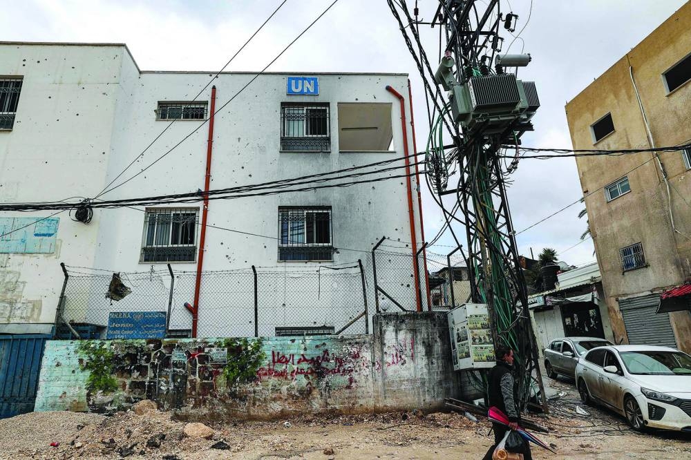 A man walks past a facility of the UN Relief and Works Agency for Palestine Refugees in the Near East (UNRWA) in the city of Jenin in the occupied West Bank, Tuesday.