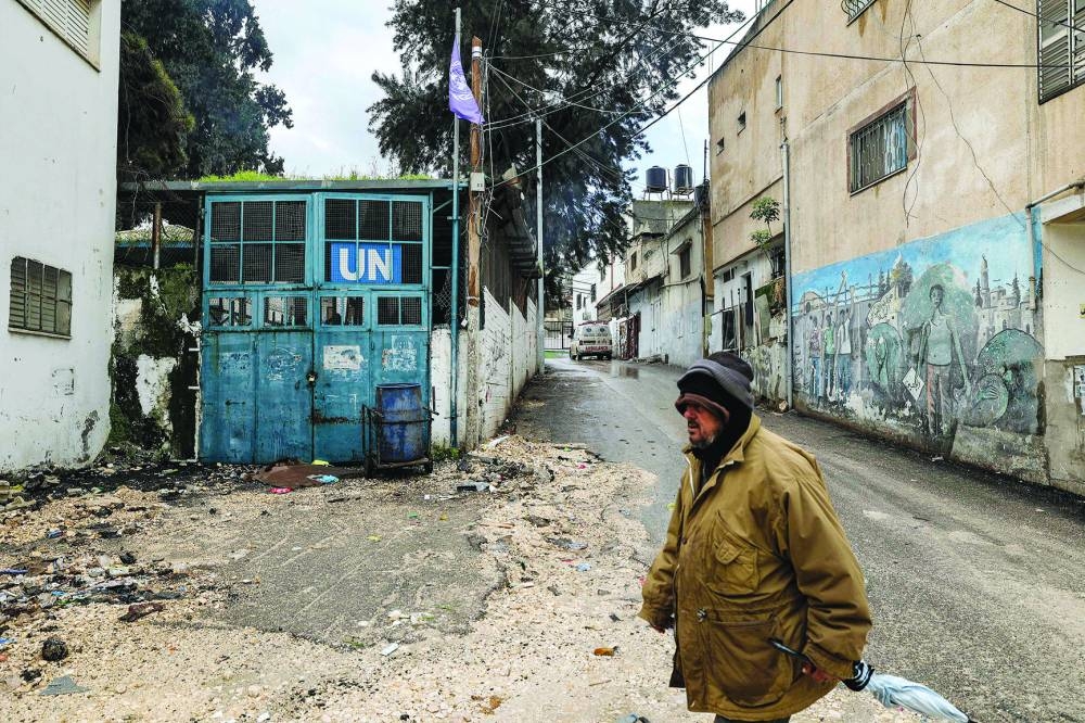A man walks near a facility of the UN Relief and Works Agency for Palestine Refugees in the Near East (UNRWA) in the city of Jenin in the occupied West Bank, Tuesday. 