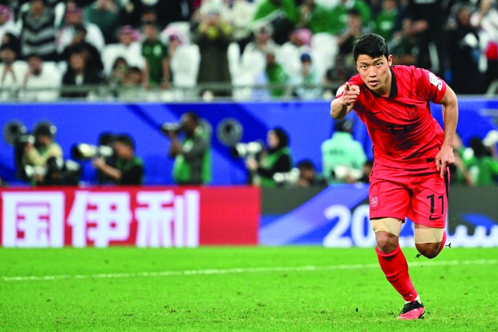 South Korea’s midfielder Hwang Hee-chan celebrates after scoring the winning penalty. (AFP)