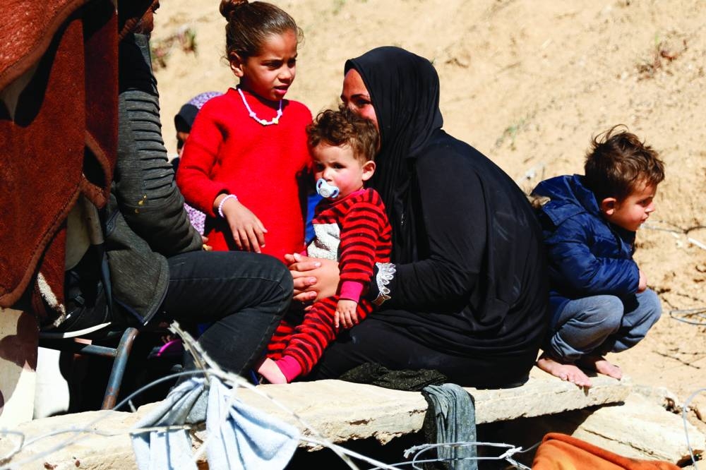 Displaced Palestinians sit outside their tent in Rafah, amid the ongoing conflict, in the southern Gaza Strip, on Wednesday.