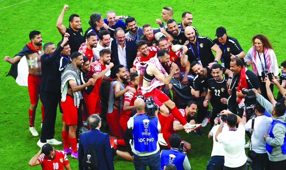 Jordan players celebrate after their win over Tajikistan in the quarter-finals of the Asian Cup at the Ahmad Bin Ali Stadium.