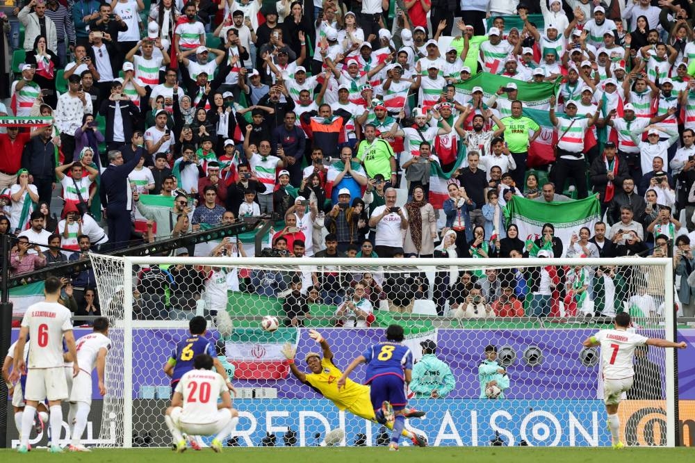 Iran's midfielder Alireza Jahanbakhsh (R) scores his team's second goal from the penalty spot. AFP
