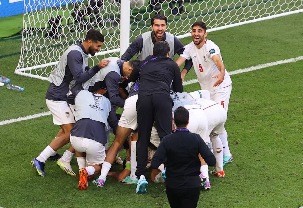 Iran's Alireza Jahanbakhsh celebrates scoring their second goal with teammates. REUTERS