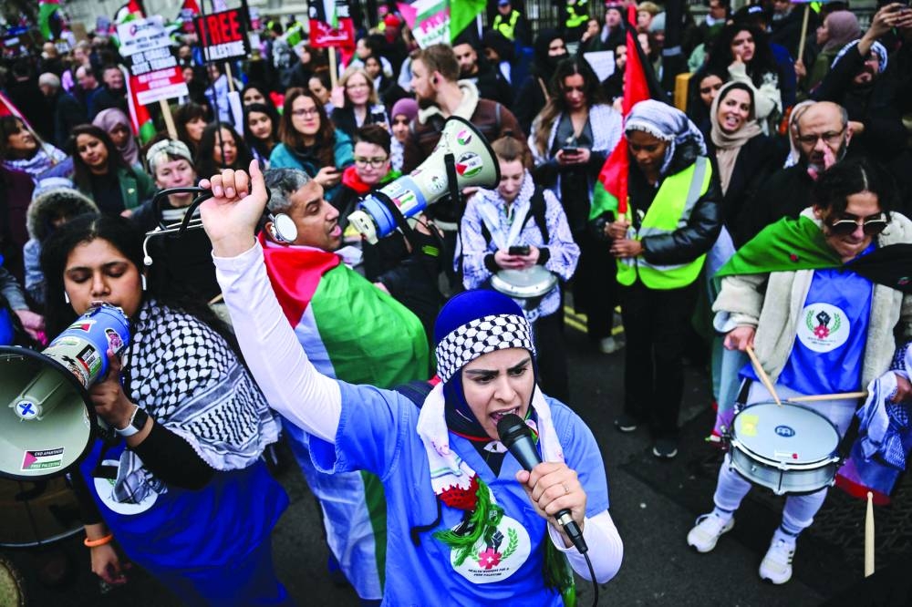 A Pro-Palestinian supporter chants slogans as she takes part in a 'National March for Palestine' in central London on Saturday.