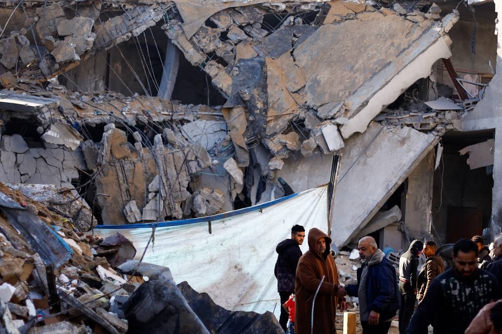 A view of a destroyed building as Palestinians inspect the site of an Israeli strike in Rafah in the southern Gaza Strip on Saturday.
