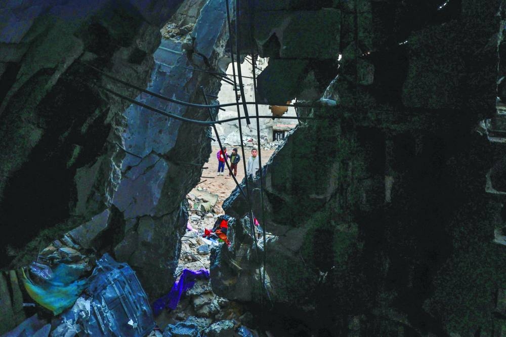 Children check the damage following Israeli bombardment in Rafah in the southern Gaza Strip.