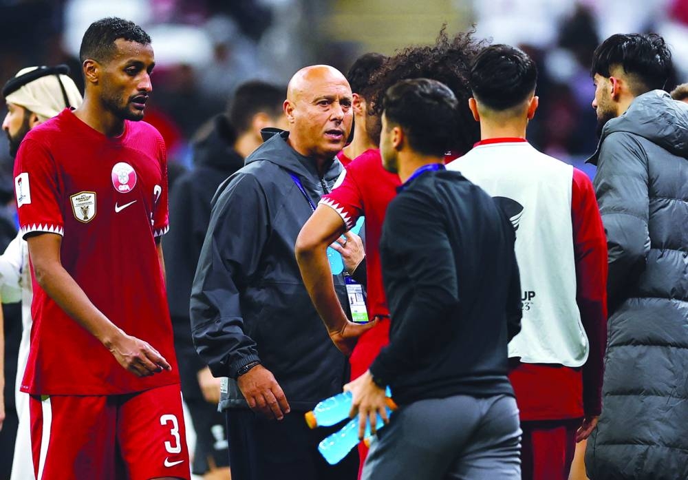 Qatar coach Marquez Lopez during his team’s AFC Asian Cup quarter-final against Uzbekistan at Al Bayt Stadium, Al Khor, on Saturday. Right: Qatar’s Akram Afif, Ismail Mohamed and Almoez Ali celebrate after winning the penalty shootout against Uzbekistan. (Reuters)