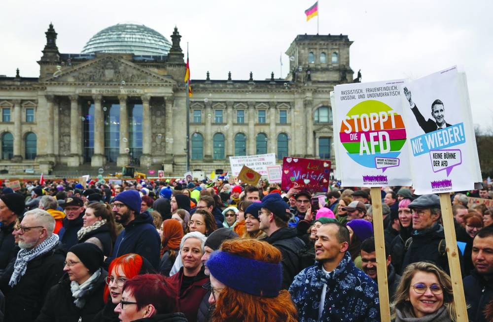 
Demonstrators protest against the far-right AfD party during a rally under the motto ‘We are the firewall’ called for by international non-profit organisation ‘Hand in Hand’ to protest against right-wing politics in front of the Reichstag building in Berlin on Saturday. (AFP) 