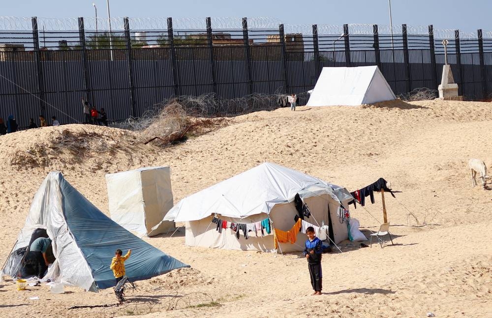 Displaced Palestinians, who fled their houses due to Israeli strikes, take shelter in a tent camp, in Rafah in the southern Gaza Strip, on Wednesday. REUTERS