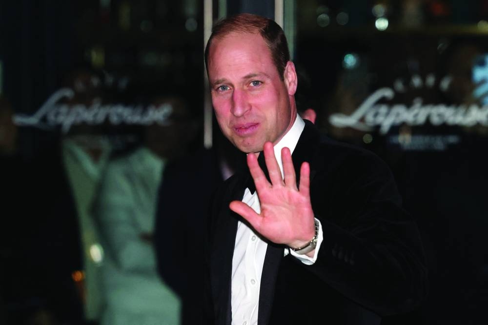 
The Prince of Wales gestures as he walks to attend London’s Air Ambulance charity gala dinner yesterday. (Reuters) 
