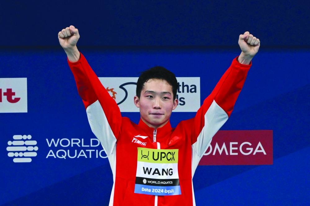 
China’s Wang Zongyuan celebrates after winning the men’s 3m springboard diving gold.  