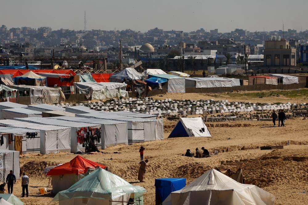 Displaced Palestinians, who fled their houses due to Israeli strikes, take shelter in a tent camp in Rafah in the southern Gaza Strip on Thursday. REUTERS