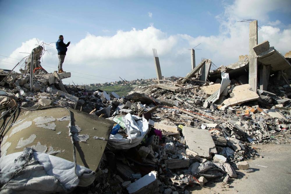 A man inspects the damage due to Israeli strikes on the southern Lebanese village of Houla near the border on Sunday 