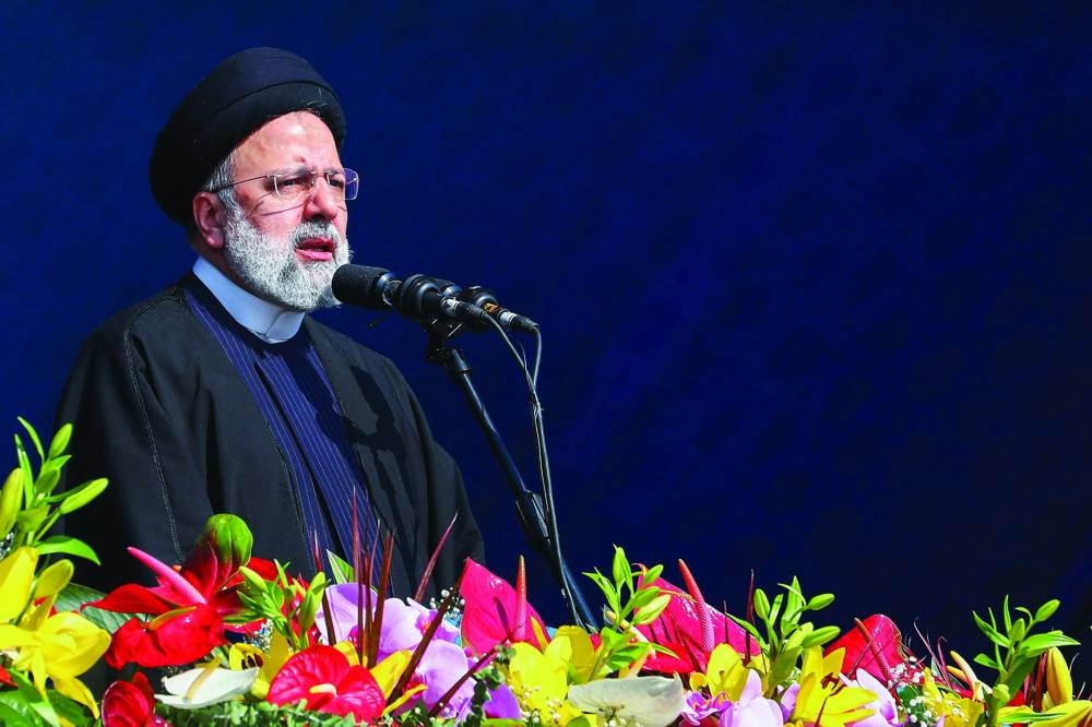 A handout picture provided by the Iranian Presidency yesterday, shows Iran’s President Ebrahim Raisi addressing the crowd in Tehran’s Azadi (freedom) square, on the occasion of the 45th anniversary of the revolution. Right: Iranians attend the 45th anniversary of the revolution in Tehran, yesterday.