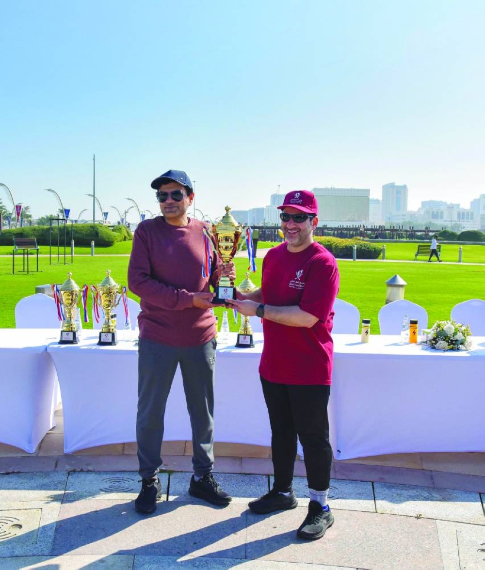QIIB CEO Dr Abdulbasit Ahmad al-Shaibei (left) honouring a senior bank executive during its Qatar National Sport Day celebrations Tuesday.