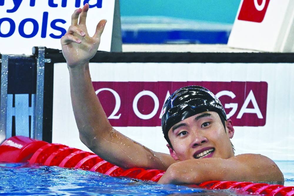 South Korea’s Hwang Sun-woo celebrates after winning the final of the men’s 200m freestyle swimming event during the 2024 World Aquatics Championships at Aspire Dome in Doha yesterday. (AFP)
