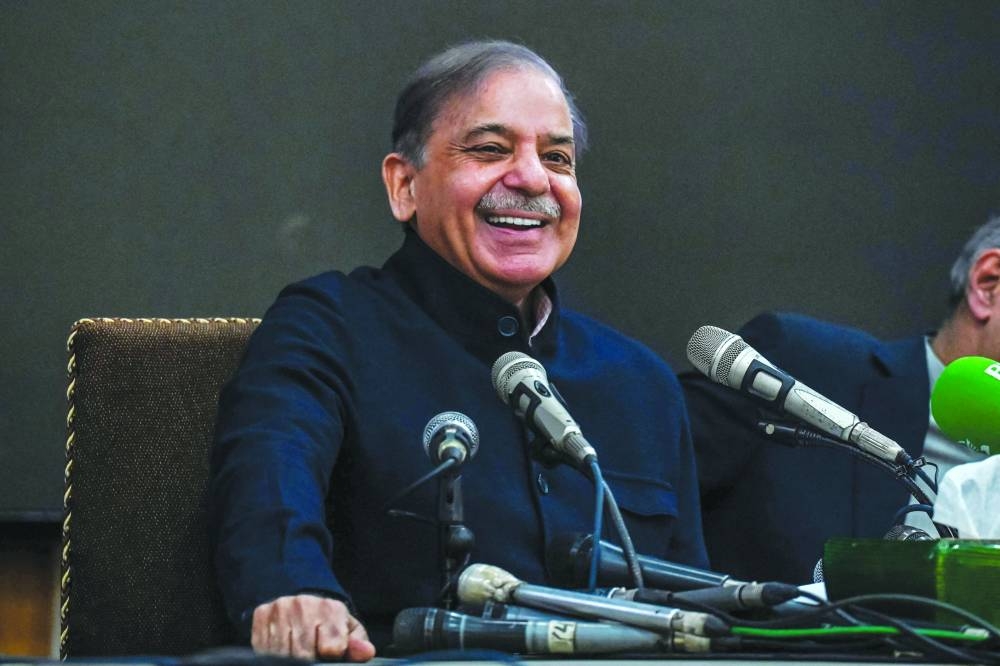 Prime Minister-in-waiting and leader of the Pakistan Muslim League-Nawaz Shehbaz Sharif speaks during a press conference in Lahore yesterday. Right: 