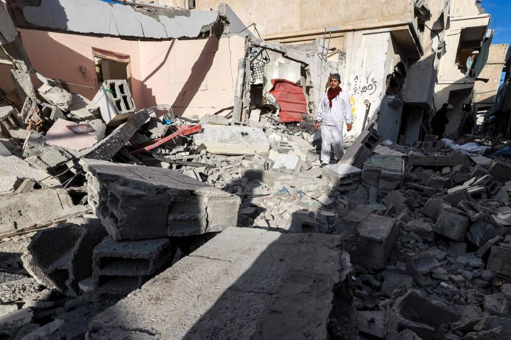 A man walks through the rubble of a building that was destroyed during Israeli bombardment in Rafah in the southern Gaza Strip, on Wednesday. AFP
