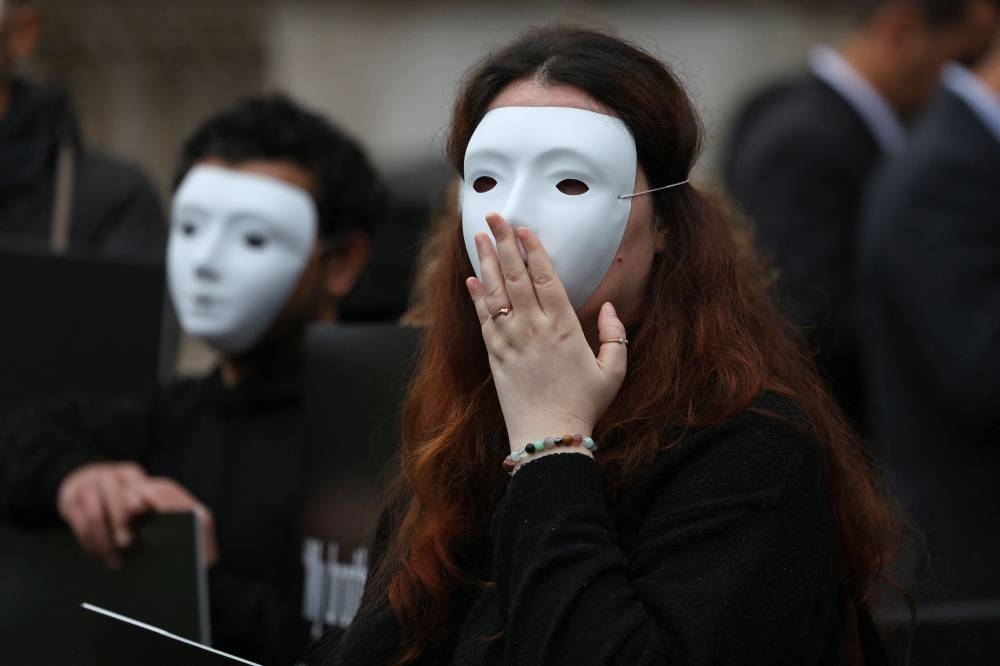 Activists from Amnesty International hold a silent vigil outside the gates of Downing Steet in central London, on Wednesday, as they call "on the UK government to use all the means at its disposal to press the Israeli authorities into reversing any decision to launch a full-scale attack on Rafah". AFP