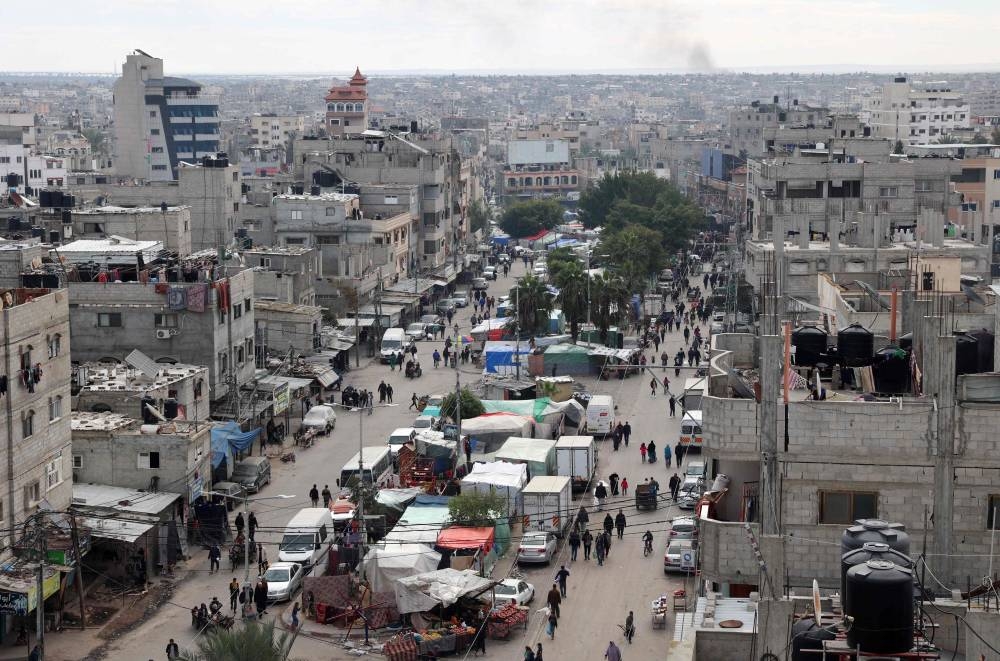 People walk past tents set up for displaced Palestinians in the heart of Rafah in the southern Gaza Strip on Wednesday. AFP