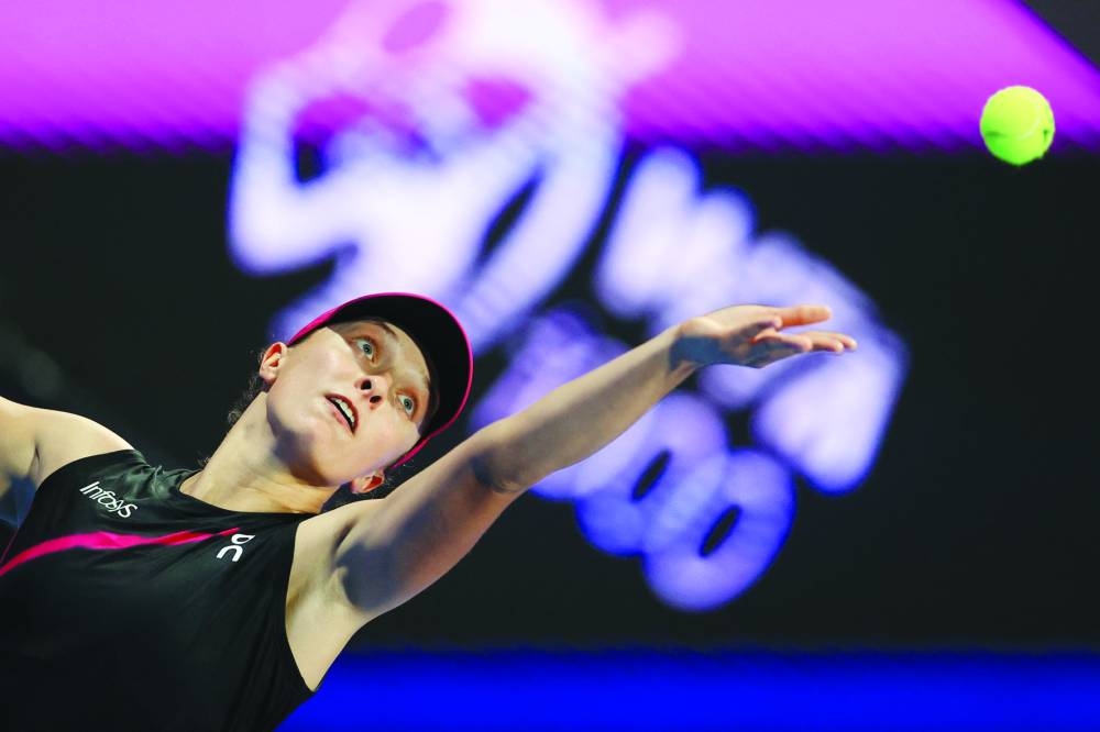 Iga Swiatek serves against Victoria Azarenka (not pictured).