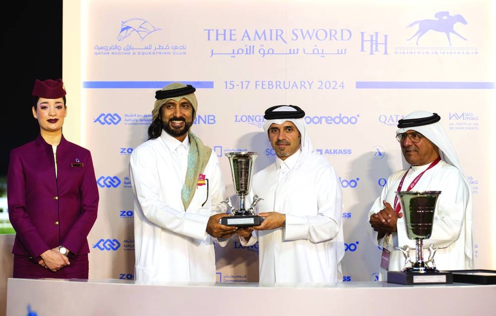Bader Mohamed al-Darwish, QREC Acting CEO, presents the trophy to a connection of Sun Amer, which won the Purebred Arabian Sand Championship at the Al Rayyan Park on Thursday.