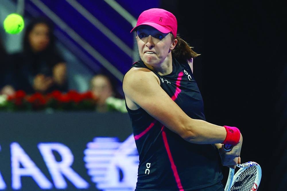 Iga Swiatek of Poland hits a return against Elena Rybakina of Kazakhstan during their women's singles final match at the Qatar Open tennis tournament in Doha on February 17, 2024. (Photo by KARIM JAAFAR / AFP)