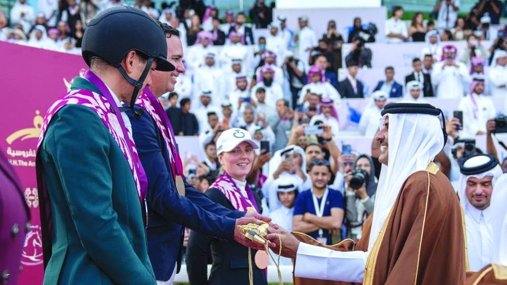His Highness the Amir Sheikh Tamim bin Hamad al-Thani presents HH The Amir Sword to Brazil’s Santiago Lambre at the Al Rayyan racecourse on Saturday. Lambre won the CSI5* Grand Prix Jump Off 1.60m class at HH The Amir International Equestrian Sword Festival to clinch the prestigious title.