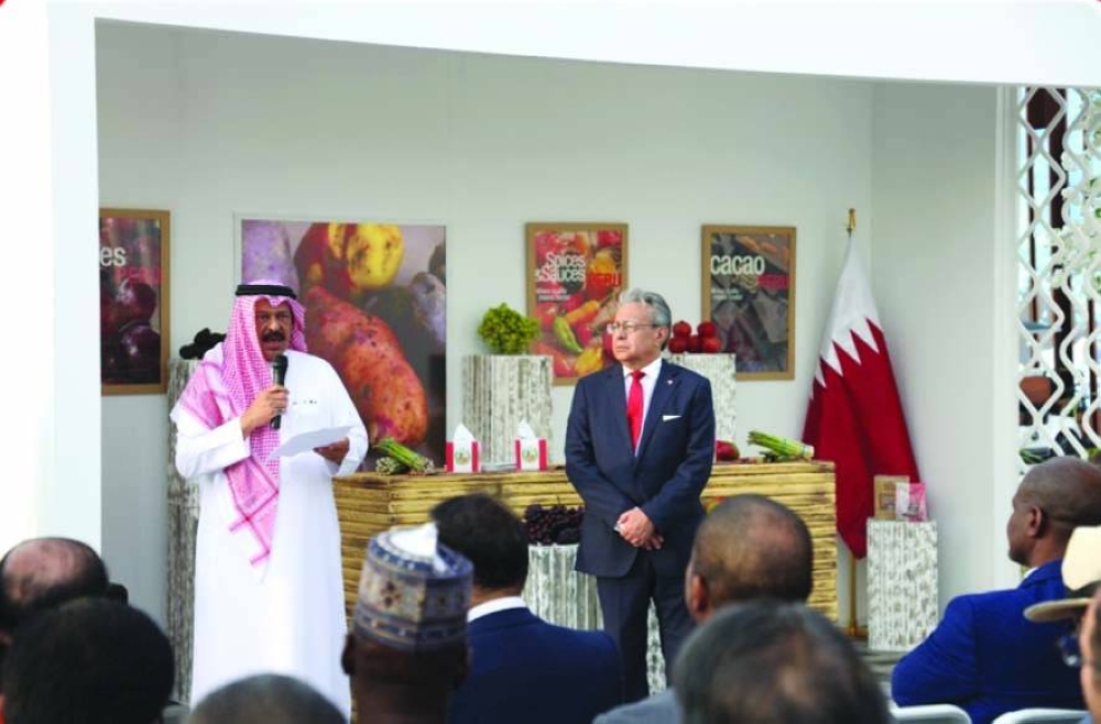 Expo 2023 Doha commissioner general ambassador Bader Omar al-Dafa speaks as Peruvian ambassador José A Benzaquen Perea looks on at the opening of the Peru Pavilion at Expo Doha 2023.