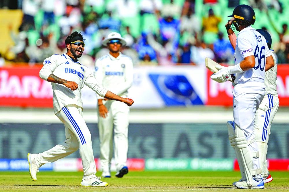 India’s Ravindra Jadeja (left) celebrates after taking the wicket of England’s Joe Root (right) during the fourth day of the third Test at the Niranjan Shah Stadium in Rajkot yesterday. (AFP)