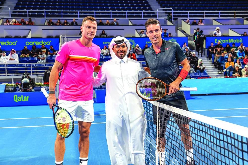 
Rashid al-Khayareen, Vice-President Strategic Relations and Public and Government Affairs Manager for ExxonMobil Qatar, poses with Marton Fucsovics (left) and Roberto Bautista Agut before their match at the Qatar ExxonMobil Open. 