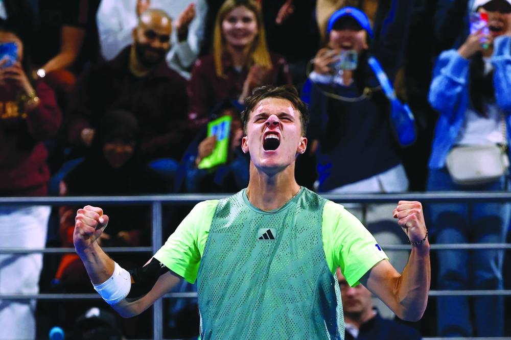 Czech Republic’s Jakub Mensik celebrates after winning the match against Great Britain’s Andy Murray at the Qatar ExxonMobil Open in Doha on Wednesday. (AFP)