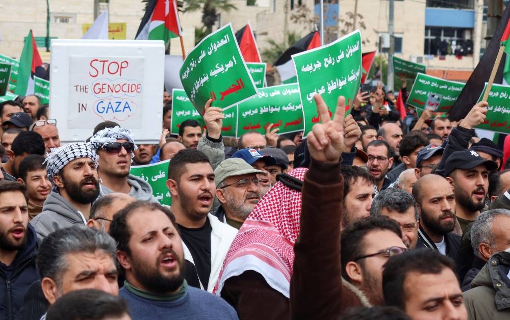 Demonstrators carry flags and banners during a protest in support of Palestinians in Gaza, in Amman, Jordan on Thursday. REUTERS