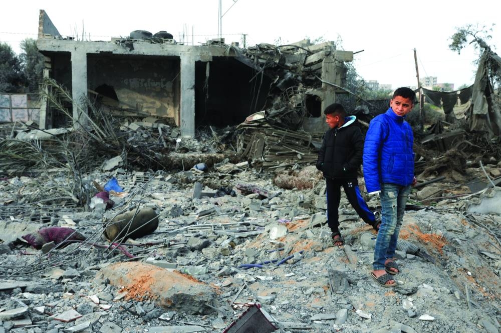 Palestinian boys inspect the site of an Israeli strike on a house, amid the ongoing conflict, in Rafah in the southern Gaza Strip, yesterday.
