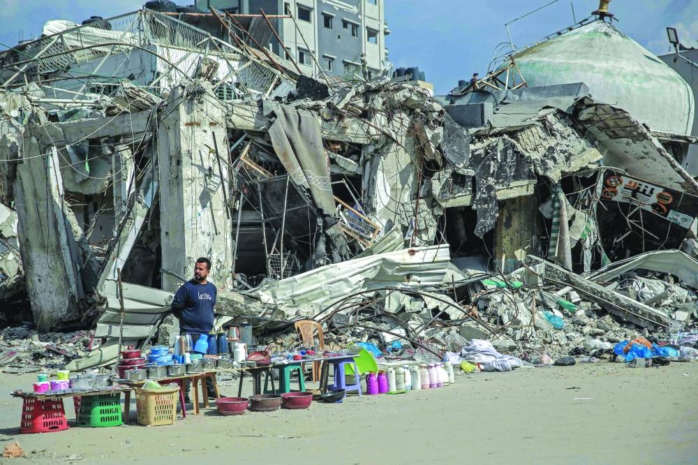 A vendor waits for customers along a street in Gaza City Saturday.