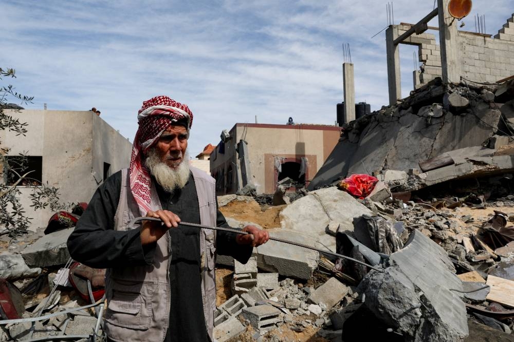 A Palestinian stands at the site of an Israeli strike on a house in Rafah in the southern Gaza Strip Friday. REUTERS