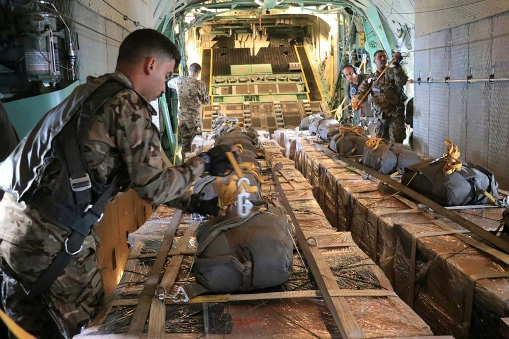 Soldiers aboard a military aircraft preparing humanitarian to be dropped over northern Gaza on Thursday. AFP/ JORDANIAN ARMY 