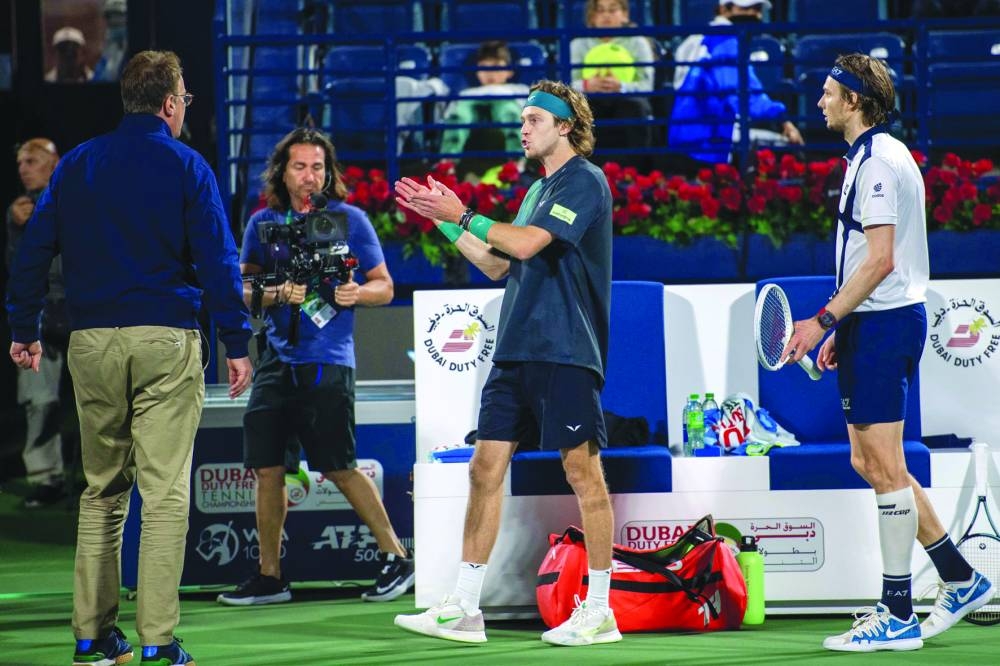 Russia's Andrey Rublev (C) argues with an official after he was defaulted, as Alexander Bublik of Kazakhstan (R) looks on after their semi-final match at the ATP Dubai Duty Free Tennis Championship in Dubai on March 1, 2024. (Photo by Ryan LIM / AFP)