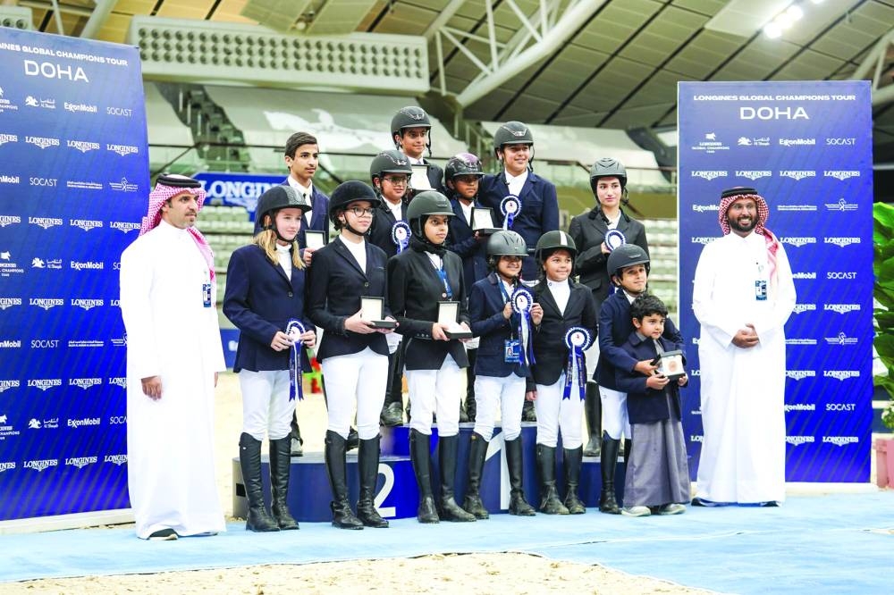 
Badr al-Darwish, President of the Qatar Equestrian Federation, and Mohamed Jaber al-Khayarin, Event Director of Global Champions Tour Doha pose with the podium finishers of the National 0.60m Optimum Time and 0.80 2 Phases Special competitions. Dalia Fakhreddine Bejaoui topped the 0.60m Optimum Time class, with Moza Hamza al-Kuwari and Fahad Nasser al-Thani finishing second and third respectively. In the 0.80 2 Phases Special class, Mohamed Saeed al-Muhannadi emerged triumphant ahead of Abdulaziz al-Maadeed and Alqaqaa Tamim al-Thani. 