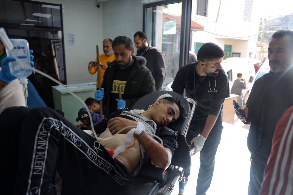 An injured man is transported on a stretcher at the Kuwaiti hospital following Israeli bombardment that hit a camp sheltering displaced Palestinians near the Emirati hospital, in Rafah in the southern Gaza Strip on Saturday. AFP