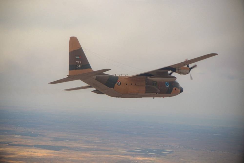 A plane from the Royal Jordanian Air Force flying during the airdrop food aid mission to Gaza, in an operation it said was being carried out with the participation of the United States for the first time.  